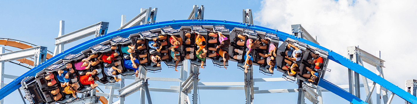 People riding a roller coaster at Six Flags theme park